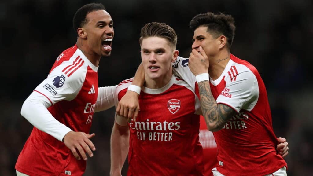 Arsenal players celebrate scoring against Tottenham