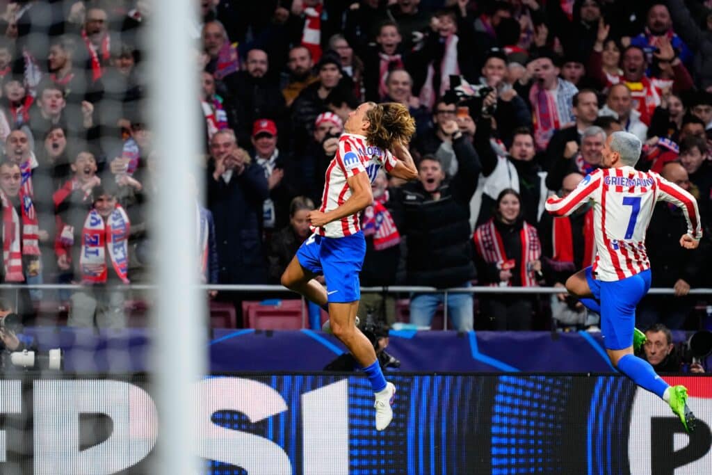 Atletico Madrid players celebrate scoring in the Champions League