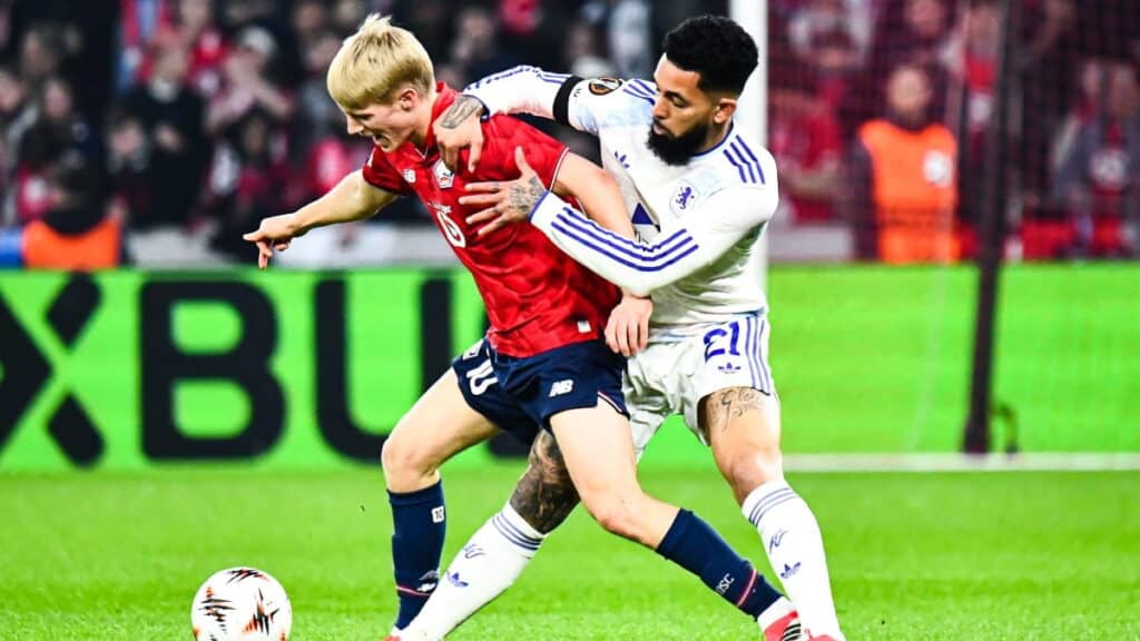 Aston Villa player battles with Lille player