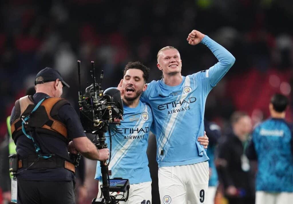 Erling Haaland and Rayan Cherki celebrate Manchester City winning the EFL Cup.