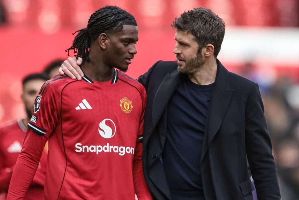 Manchester United interim boss Michael Carrick puts his arm around teenage defender Ayden Heaven