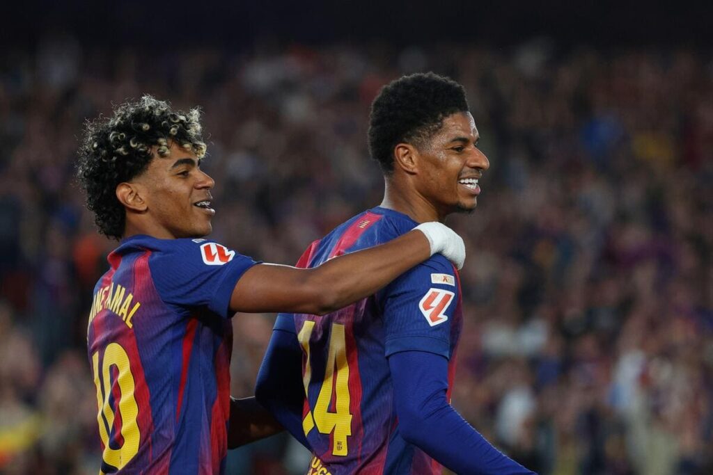 Marcus Rashford and Lamine Yamal celebrate a goal for Barcelona.
