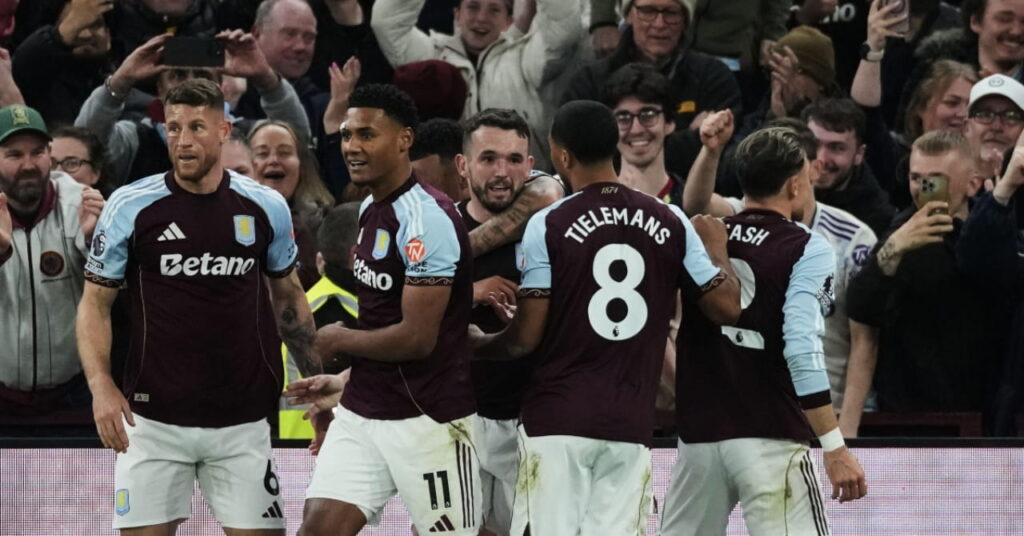 Aston villa players celebrate scoring against Liverpool
