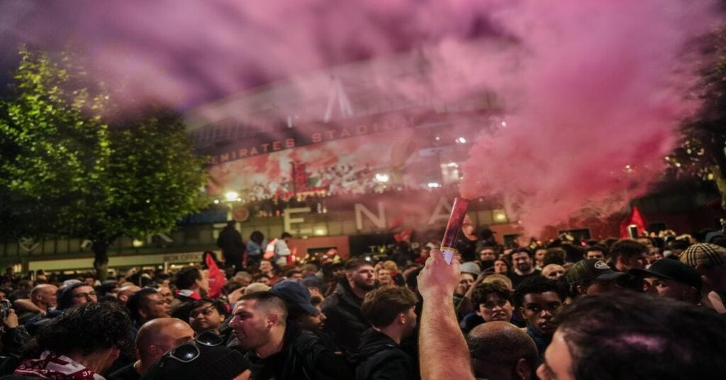 Arsenal fans celebrate their club winning the Premier League title
